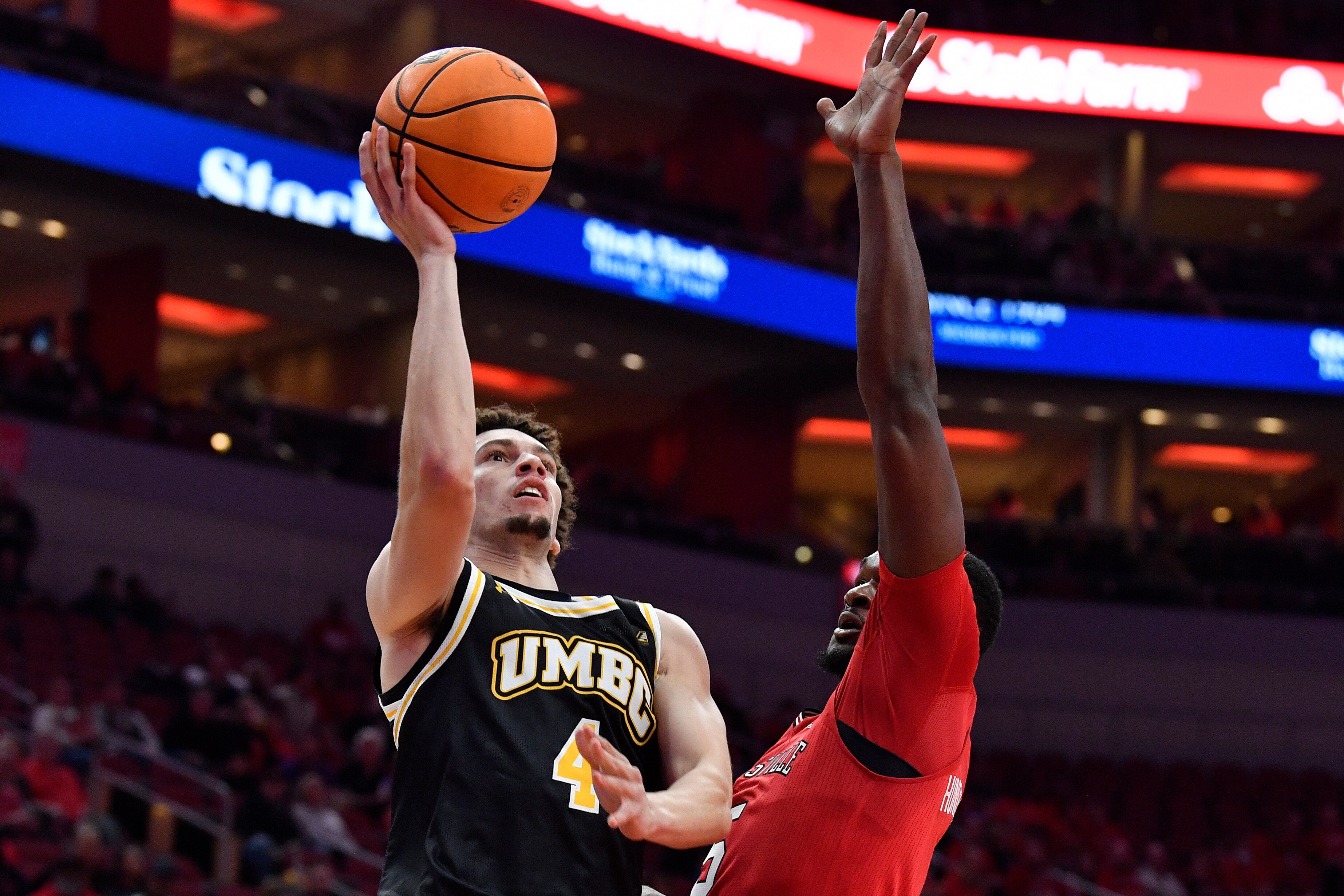 Maryland Baltimore County guard Marlon Short (4) shoots over the defense of Louisville forward Brandon Huntley-Hatfield (5) during the first half of an NCAA college basketball game in Louisville, Kentucky, on Monday, Nov. 6, 2023.
