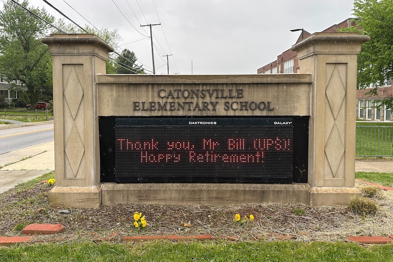 A digital sign outside Catonsville Elementary School, pictured on April 25, honors Bill Trentler after his retirement from UPS.