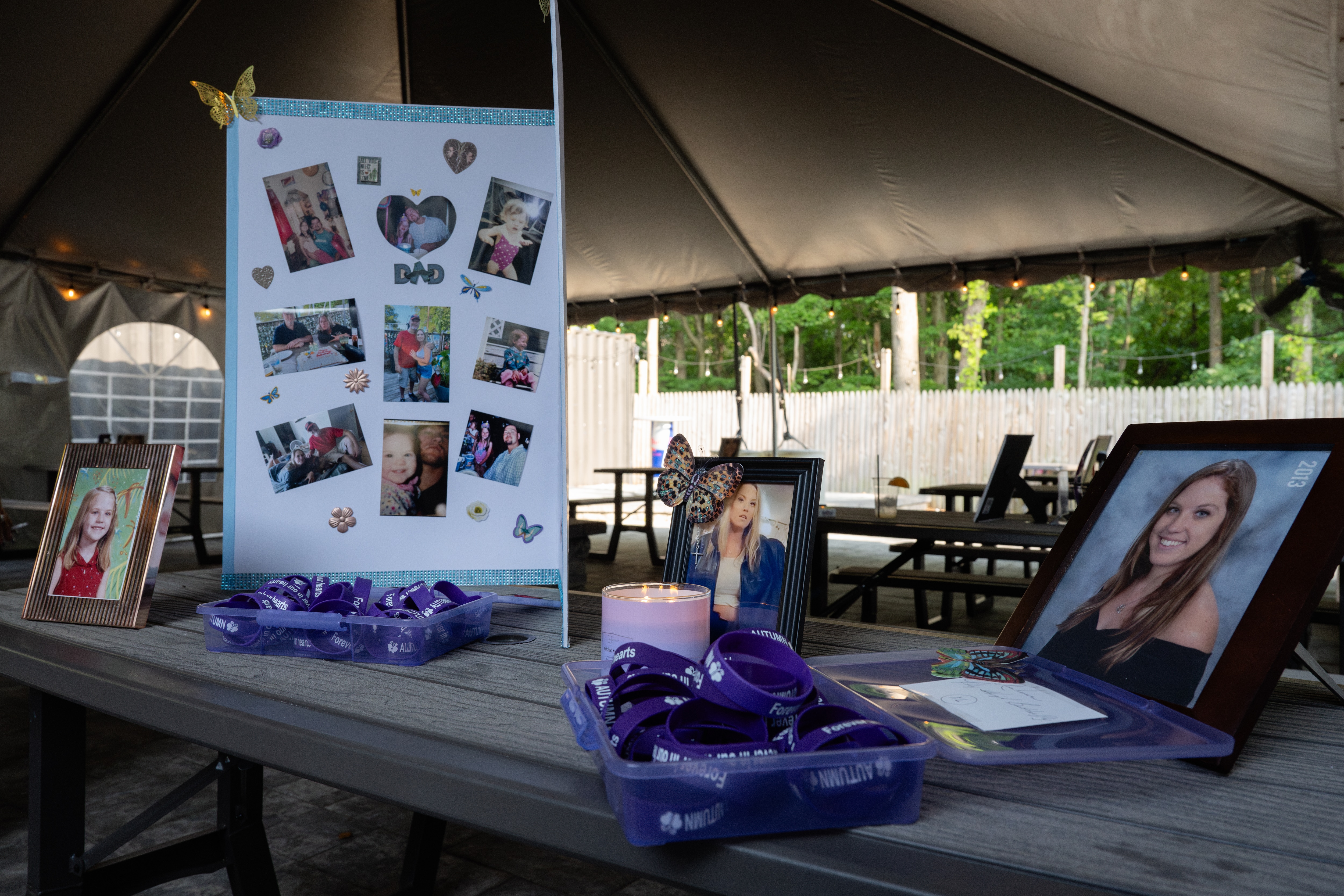 Photographs of Autumn Harvey are displayed at Tavern in the Quarters, Harvey's favorite local bar, during a vigil held in her honor on in Middle River on July 14, 2024.
