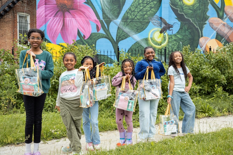 A Girl Scouts troop receiving Embold hair kits at the conclusion of an Embold Workshop.