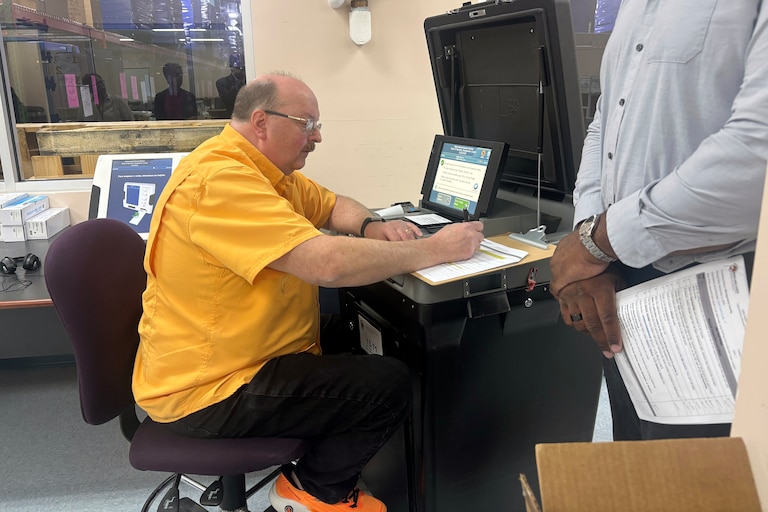Montgomery County elections IT technician Tim Gartrell demonstrates machine logic and accuracy testing on Thursday at the elections board office in Gaithersburg.