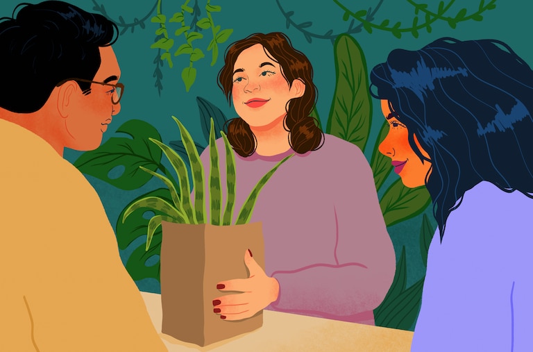 Couple buying houseplant at counter in plant shop