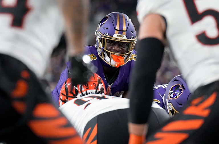 Baltimore Ravens quarterback Lamar Jackson (8) smiles before handing the ball off to Derrick Henry for a touchdown during a Thursday Night Football game against the Cincinnati Bengals at M&T Bank Stadium in Baltimore, Md., on November 7, 2024. The Baltimore Ravens won, 35-34.