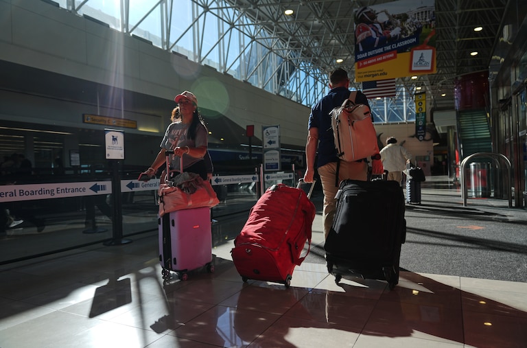 Travelers walk through the terminal at Baltimore/Washington International Thurgood Marshall Airport in Baltimore, Thursday, Nov. 6, 2025.