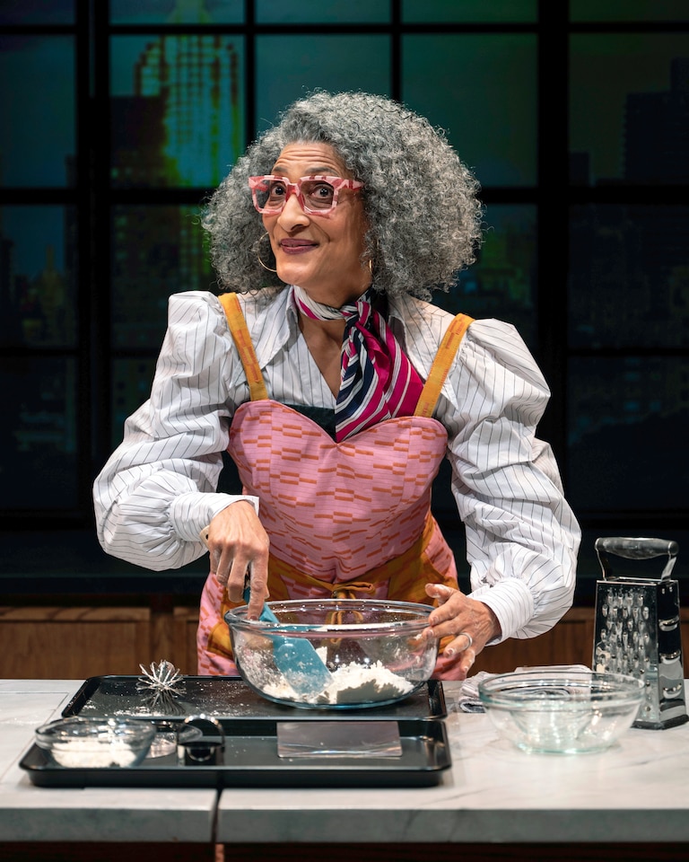 Carla Hall, a chef who has appeared on a slew of food TV shows, walks a faux studio audience through baking a biscuit while receiving myriad notes from producers in her ear during the show.