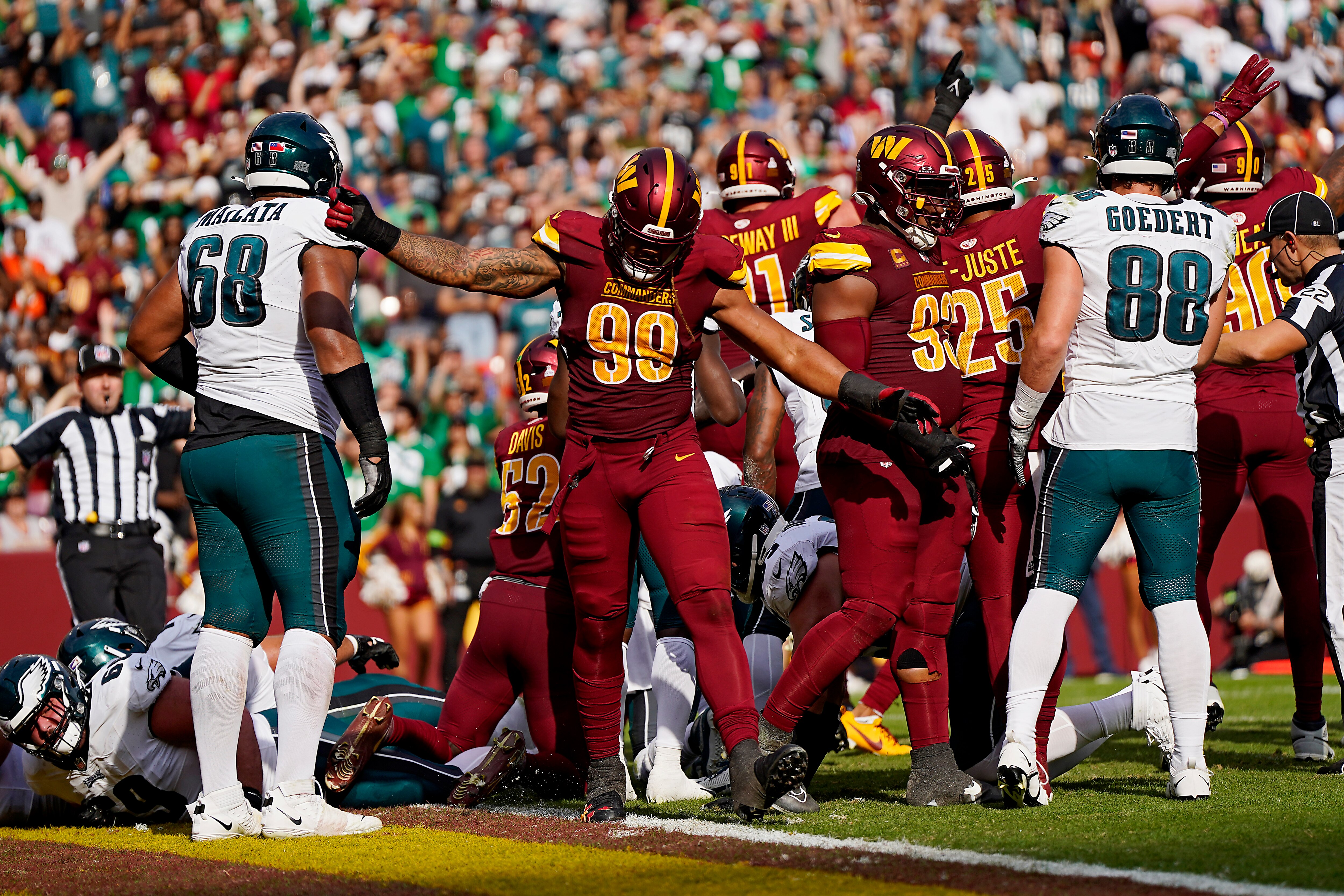 Chase Young (99) of the Commanders celebrates after forcing a turnover in the third quarter of Sunday's 38-31 loss to the Eagles.