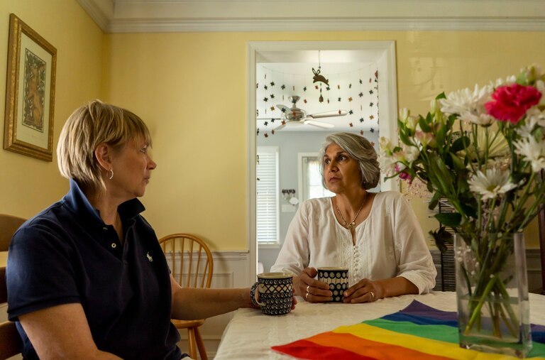 Gita Deane and Lisa Polyak sit and chat in their home in Baltimore.
