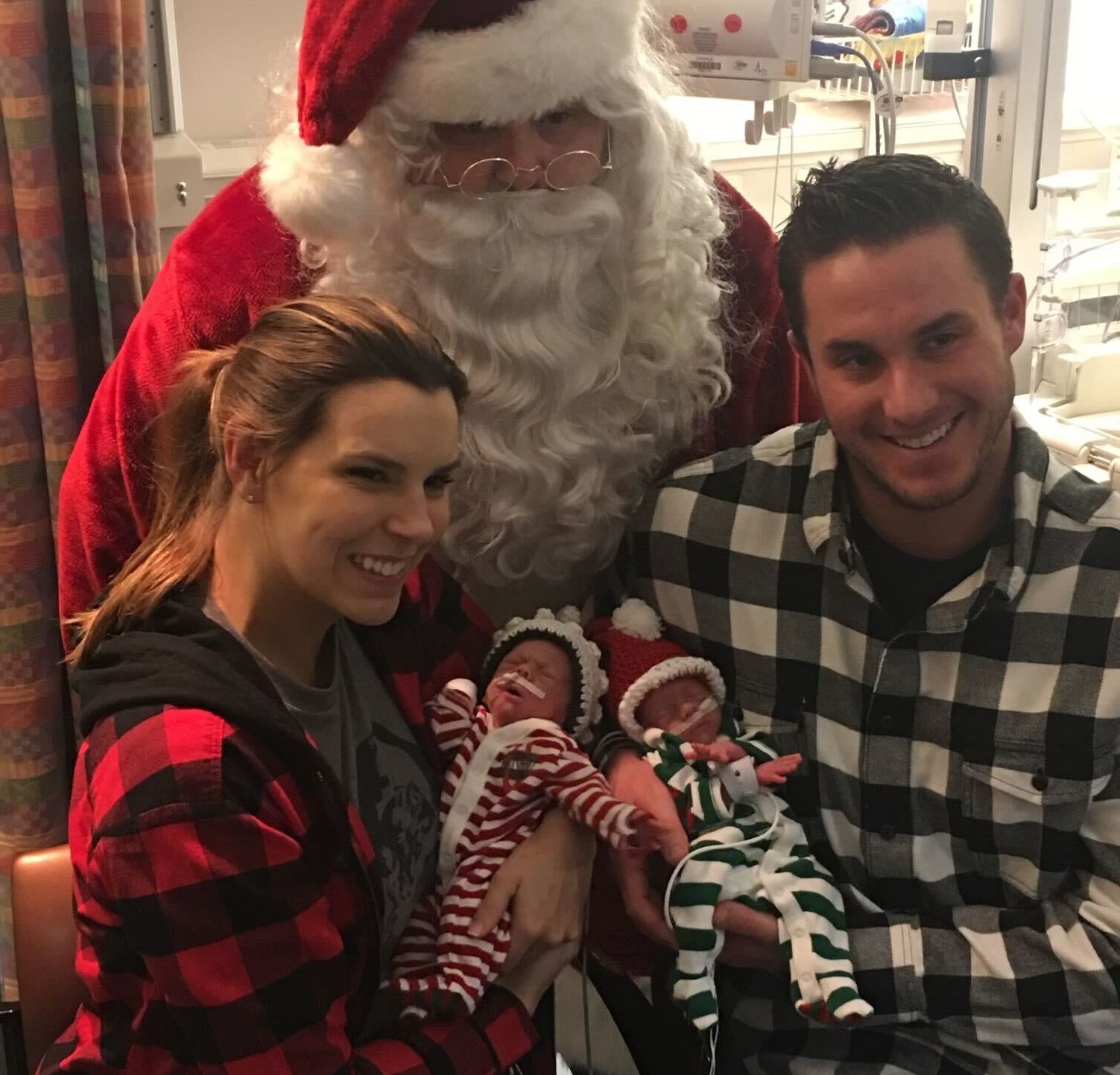 Orioles catcher James McCann, right, and his wife Jessica, left, hole their twins, Christian and Kane, during a visit from Santa Claus at the Vanderbilt University Medical Center in 2017.
