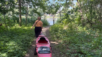 Wednesday, June 17, 2026 - Lisa Arrasmith, a longtime public water access advocate, hauls her kayak down to the water at Beachwood Park in Anne Arundel County on Wednesday.
