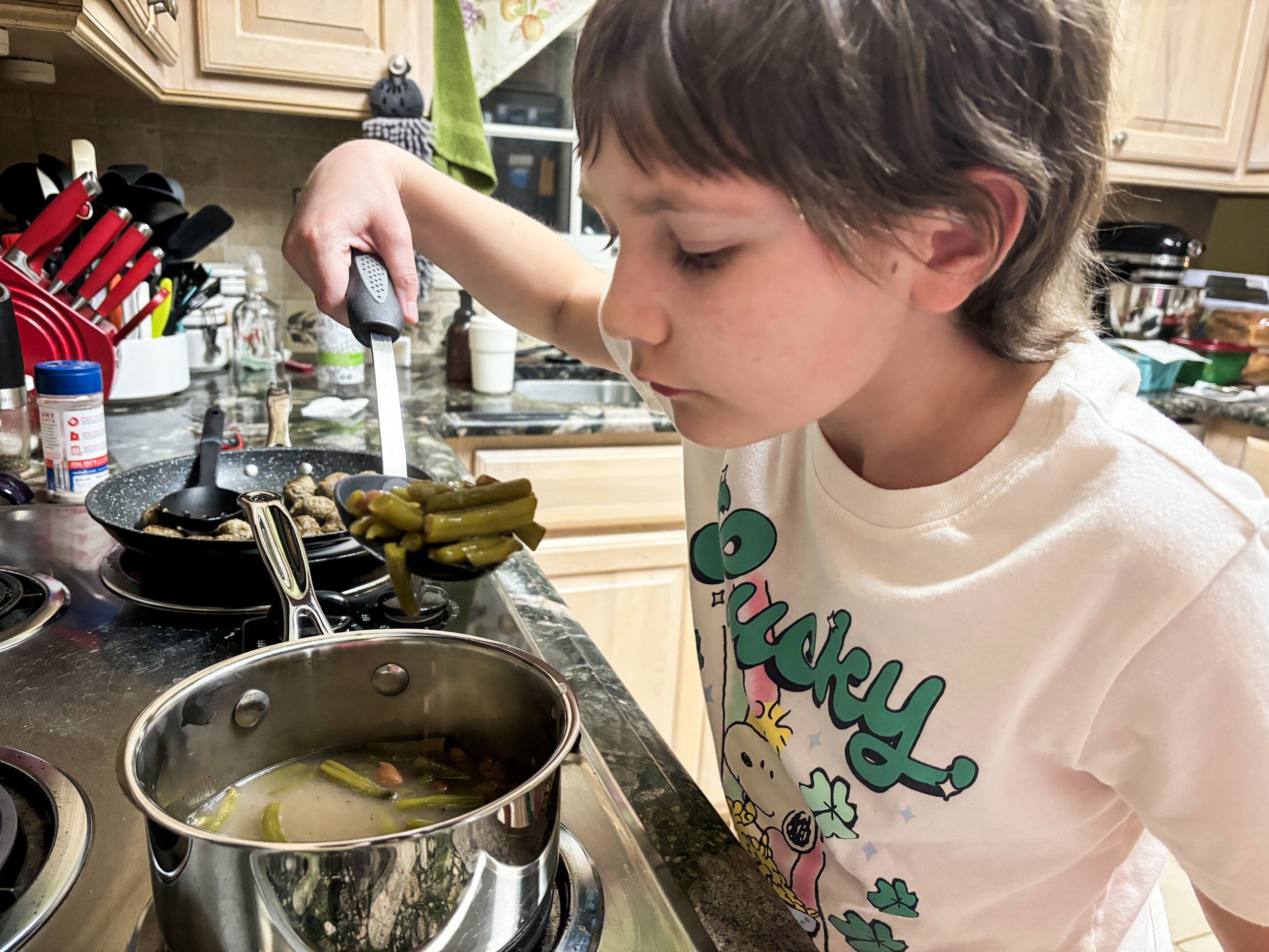 Phoebe Dunkle, 10, prepares a meal at home last week.