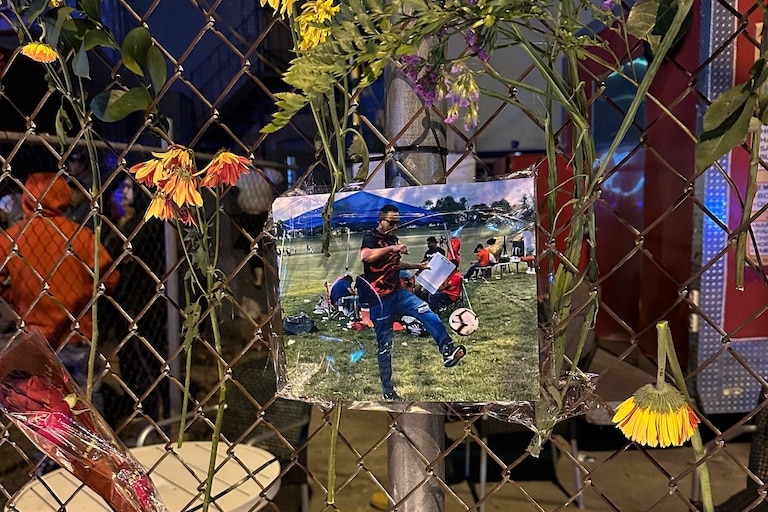 A photo of Kevin Torres hangs on a fence at a makeshift memorial at the ChrisT bar on the northern edge of Highlandtown. Torres was fatally shot by a security guard at the bar early Monday morning.