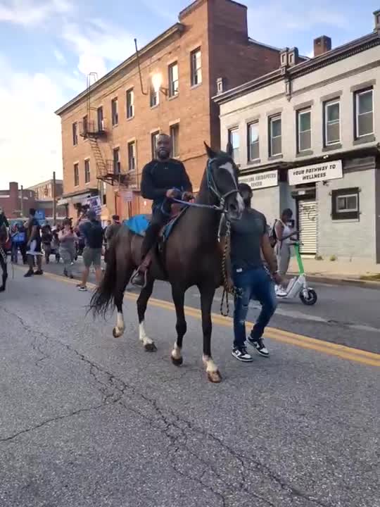 Community members march to honor Bilal "BJ" Abdullah in West Baltimore.