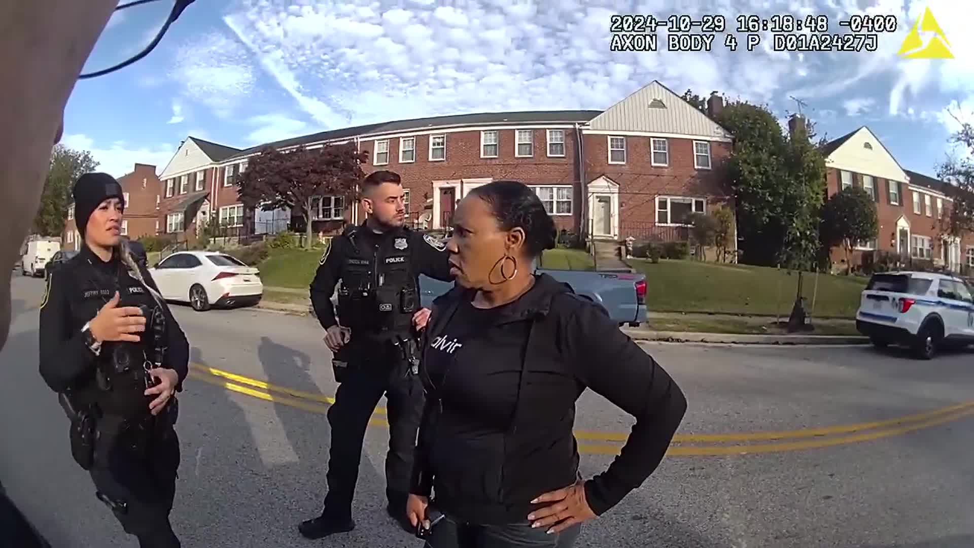 Retired captain Jackie Conway talks to Baltimore County Police officers before her arrest after she reported one of her DoorDash customers answered the door.